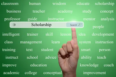 tangan menunjuk searching bar bertuliskan scholarship