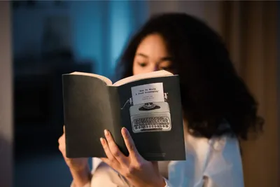 Seorang wanita sedang membaca buku.